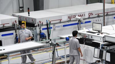 Saudis work at a solar panel factory in Riyadh. Increasing the validity will help to sustain factories and reduce review periods by investors. AFP