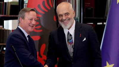 British Foreign Secretary David Cameron, left, and Albanian Prime Minister Edi Rama shake hands in Tirana. AFP