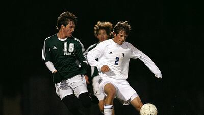 Two players vie for control of the ball.