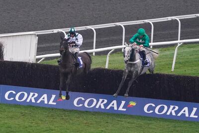 SUNBURY, ENGLAND - JANUARY 15: James Bowen riding Caribean Boy (green) clear the last to win The Coral Committed To Safer Gambling Handicap Chase at Kempton Park Racecourse on January 15, 2022 in Sunbury, England. (Photo by Alan Crowhurst / Getty Images)