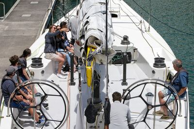 AUCKLAND, NEW ZEALAND - DECEMBER 31: A group departs on an Explore 'America's Cup' yacht for a trip around the harbour on December 31, 2021 in Auckland, New Zealand. Auckland moved to the orange traffic light setting of New Zealand's new COVID-19 Protection Framework at 11.59 pm on Thursday, December 30. Aucklanders are now able to enjoy most activities including the traditional travel out of the city for the holiday season leaving the remainder to enjoy recreational activities in the city. (Photo by Dave Rowland / Getty Images)