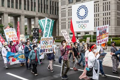 Protesters march in front of the metropolitan government building during a demonstration against the forthcoming Tokyo Olympic Games. Getty Images
