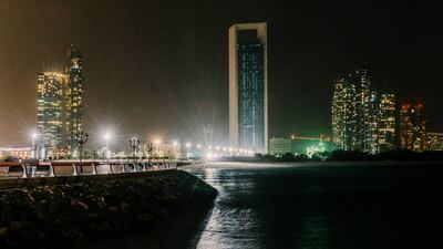 Abu Dhabi, UAE. March 25th 2017. The ADNOC building (C) with its main lights off during Earth Hour 2017 when, between 20:30 and 21:30, a WWF initiative encrouages residents and businesses to turn off their lights. In Abu Dhabi, Earth Hour achieved mixed results, with many buildings along the skyline keeping their lights on. Alex Atack for The National.