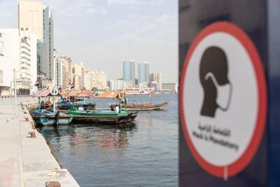 Signs in Deira, Dubai reminder people that masks are mandatory in all public places. Antonie Robertson / The National