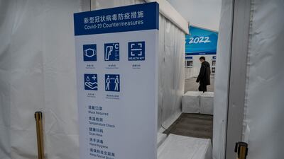 BEIJING, CHINA - JANUARY 19: A list of COVID prevention measures are seen on a sign at a security check outside a fenced area next to the National Stadium, also known as the Bird"u2019s Nest, that will be part of the closed loop "u2018bubble"u2019 for visitors and locals taking part in the Beijing 2022 Winter Olympics and Paralympics, at the Olympic Park on January 19, 2022 in Beijing, China. Foreign and local athletes, officials, journalists, and support workers for the Winter Olympics are required to stay in a bubble to prevent the spread of coronavirus as China continues to maintain its zero COIVD policy. The games are set to open on February 4th. (Photo by Kevin Frayer / Getty Images)