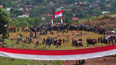 People join a ceremony for celebrating Indonesia's 77th Independence Day at Kedumulyo village, in Pati, Central Java province, Indonesia, August 17, 2022, in this photo taken by Antara Foto. Antara Foto/Yusuf Nugroho/ via REUTERS ATTENTION EDITORS - THIS IMAGE HAS BEEN SUPPLIED BY A THIRD PARTY. MANDATORY CREDIT. INDONESIA OUT. NO COMMERCIAL OR EDITORIAL SALES IN INDONESIA.