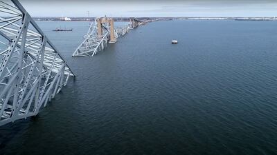 This handout screegrab courtesy of the National Transportation Safety Board taken on March 26, 2028, shows part of the steel frame of the Francis Scott Key Bridge sitting after the bridge collapsed in Baltimore, Maryland, on March 26, 2024. A major bridge collapsed in Baltimore on March 26, 2024, blocking one of the busiest US commercial harbors, after a heavily laden cargo ship lost power and smashed into a support column despite desperate attempts to stop in time. Six people -- all members of a nighttime construction crew repairing potholes on the Francis Scott Key Bridge -- were missing and feared dead, according to officials and media reports. (Photo by National Transportation Safety Board / Youtube / AFP) / RESTRICTED TO EDITORIAL USE - MANDATORY CREDIT "AFP PHOTO / National Transportation Safety Board / Youtube - NO MARKETING NO ADVERTISING CAMPAIGNS - DISTRIBUTED AS A SERVICE TO CLIENTS