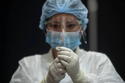 A health worker prepares a syringe for administering the AstraZeneca Covid-19 coronavirus vaccine to people at the mass vaccination site inside the Siam Paragon shopping mall. Getty Images