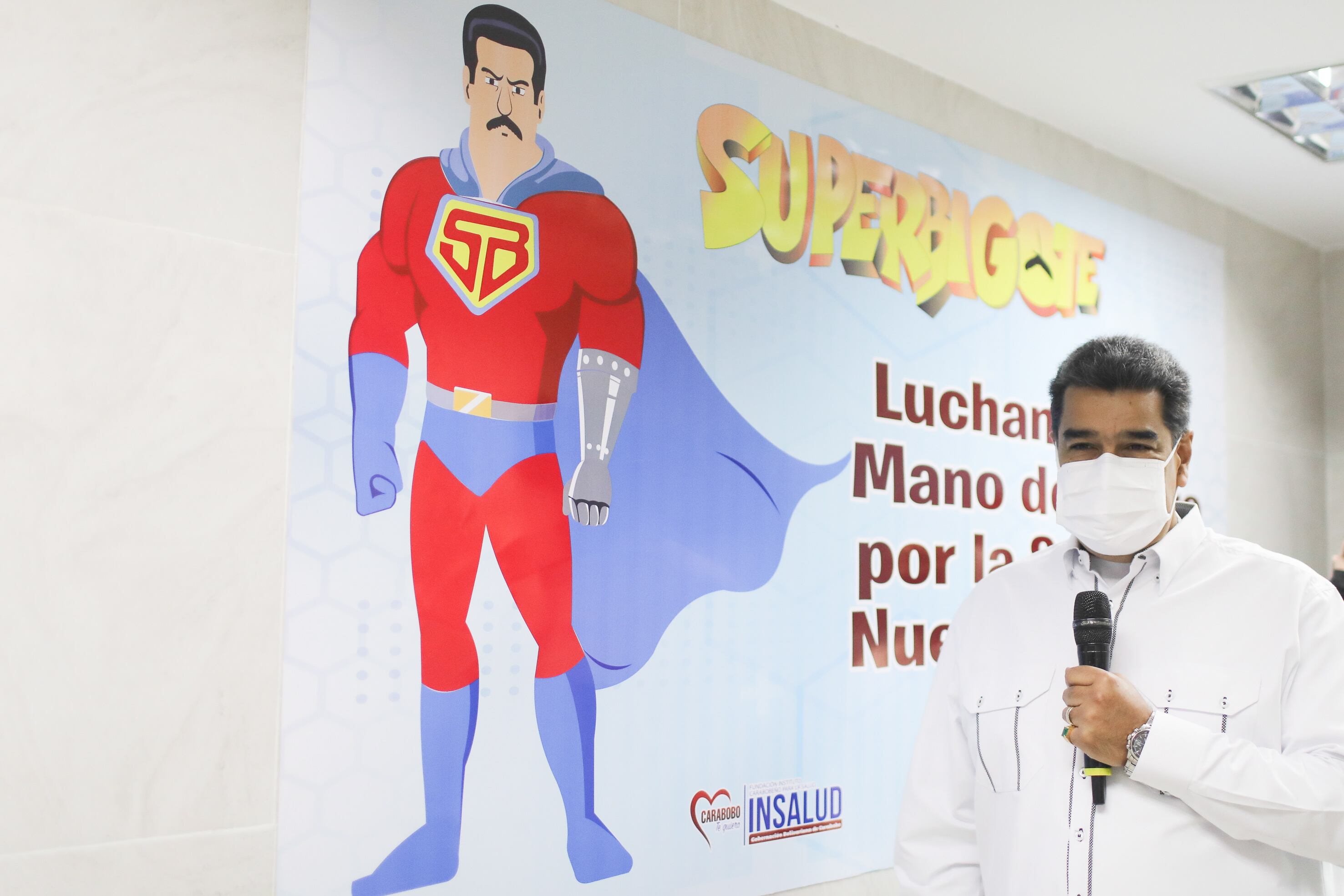 A handout photo made available by the press office of the Miraflores Palace shows the president of Venezuela, Nicolas Maduro, next to an image of the cartoon 'Superbigote' during a visit to the Dr. Miguel Malpica de Guacara Hospital, in the state of Carabobo, Venezuela, 26 May 2022. The president of Venezuela, Nicolas Maduro, proposed to appoint 'secret inspectors' for each hospital in the country to control and help health centers to be 'reborn' and 'strengthened'. EPA / Prensa Miraflores HANDOUT EDITORIAL USE ONLY / NO SALES / ONLY AVAILABLE TO ILLUSTRATE THE ACCOMPANYING NEWS / MANDATORY CREDIT HANDOUT EDITORIAL USE ONLY / NO SALES
