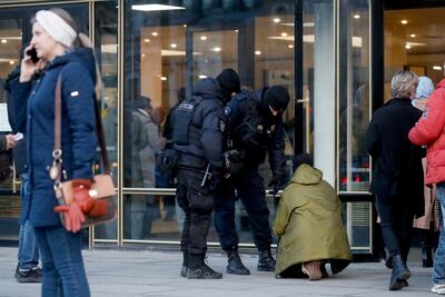 Police officers check a person outside the Oktyabrsky Concert Hall, amid heightened security measures, prior to the concert of the rock group 'Picnic' in St. Petersburg, Russia, on March 27. EPA