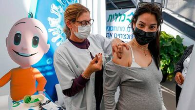 A pregnant woman receives a Pfizer-BioNtech coronavirus vaccine dose in Tel Aviv on January 23, 2021. Dubai will now roll out the vaccine to women who are 13 weeks or more into their pregnancy. AFP