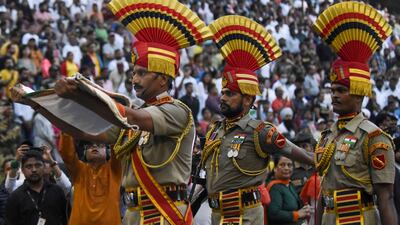 This picture taken on August 15, 2022, shows Indian Border Security Force (BSF) soldiers taking part in the Beating the Retreat ceremony during India's 75th Independence Day celebrations at the India-Pakistan Wagah border post, about 35km from Amritsar. (Photo by Narinder NANU / AFP)