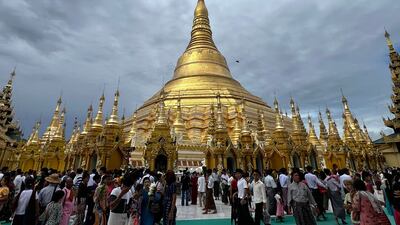 Devotees visit Shwedagon Pagoda as Buddhists mark Buddha's Birthday, which falls on the Full Moon Day of Kasone, in Yangon on May 22, 2024. Thousands of Buddhist devotees gathered at Myanmar's Shwedagon Pagoda on May 22 to mark the Buddha's birthday and to water a sacred Bodhi tree to mark a full moon festival. (Photo by Sai Aung MAIN / AFP)