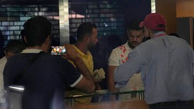 Lebanese depositors inside a Blom Bank branch in Beirut. A group of customers, at least one of whom was armed, took hostages in the bank, demanding access to their savings. They were reportedly able to withdraw $20,000 from an account of one of the depositors before they left. EPA