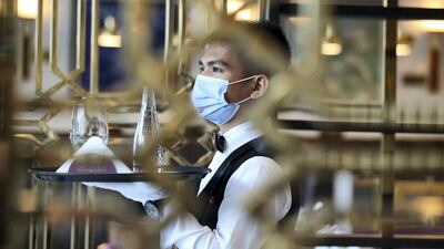Dubai, United Arab Emirates - Reporter: N/A. News. Coronavirus/Covid-19. An employee at brings drinks to customers at Cafe Society in Dubai. Wednesday, November 11th, 2020. Dubai. Chris Whiteoak / The National
