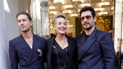 MILAN, ITALY - FEBRUARY 26: Adam Senn, Sharon Stone and Sam Webb attend a photocall during a Dolce & Gabbana boutique event during the Milan Fashion Week Fall/Winter 2022/2023 on February 26, 2022 in Milan, Italy. (Photo by Andreas Rentz / Getty Images)