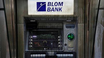 An ATM is covered with diesel fuel, vandalised by angry depositors. AP photo