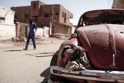 A burnt vehicle in Omdurman, Sudan. EPA