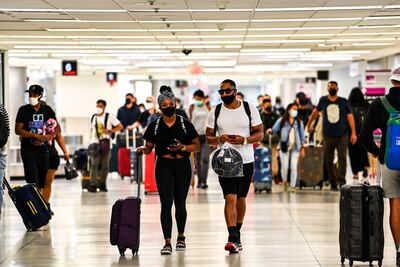 Travellers are hoping the UK government will change the UAE's traffic light status. AFP / CHANDAN KHANNA