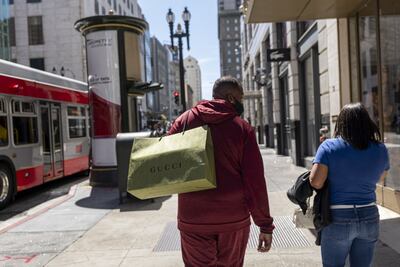 A pedestrian carries a Gucci branded shopping bag in San Francisco, California, US, on Wednesday, May 18, 2022. US retail sales grew at a solid pace in April, reflecting broad-based gains and suggesting demand for merchandise remains resilient despite rampant inflation. Photographer: David Paul Morris / Bloomberg