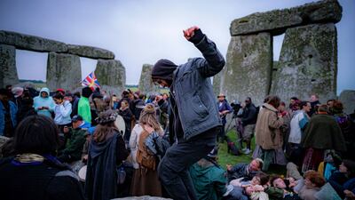 People inside the stone circle during Summer Solstice at Stonehenge. The prehistoric monument, a UNESCO heritage site, had been closed for the celebrations due to the coronavirus lockdown, but people ignored the lockdown. AP