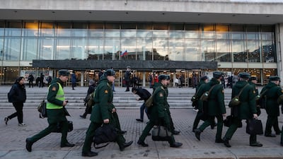 Military cadets walk in front of the Oktyabrsky Concert Hall on March 27. EPA