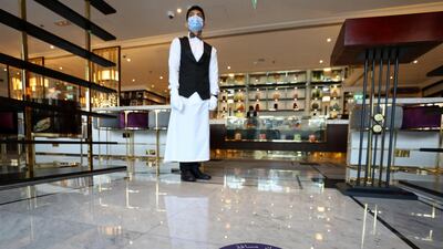 Dubai, United Arab Emirates - Reporter: N/A. News. Coronavirus/Covid-19. An employee waits to take customers temperatures at Cafe Society in Dubai. Wednesday, November 11th, 2020. Dubai. Chris Whiteoak / The National