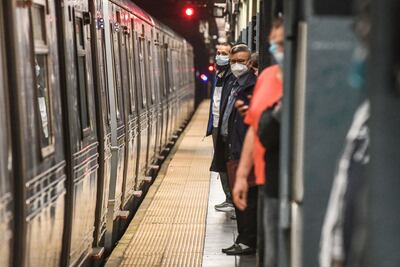 Commuters wait on the platform at the Times Square subway station in New York, US, on Wednesday, May 25, 2022. New York City's subway system is carrying fewer riders than expected this year as crime has spiked, including a fatal shooting on Sunday and a violent subway attack last month that shook the city. Photographer: Stephanie Keith / Bloomberg
