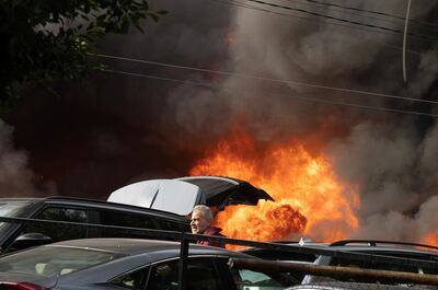 A man tries to remove his car after a fire broke out at a parking lot, caused by a power generator, in Hamra, Beirut, Lebanon November 9, 2024. REUTERS / Adnan Abidi