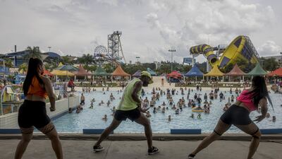 Performers dance near a wave pool at a water park in Itupeva, Sao Paulo state, Brazil, on Saturday, Jan. 15, 2022. South America has been grappling with a record heatwave driven by the La Nina pattern that has caused extreme weather across the region. Photographer: Victor Moriyama / Bloomberg