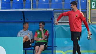 Belgium's goalkeeper Thibaut Courtois (R) arrives to the pitch as Belgium's defender Jan Vertonghen (C) speaks with a coach during their MD-1 training session at Petrovskly Stadium in St Petersburg on June 11, 2021 on the eve of their UEFA EURO 2020 match against Russia. (Photo by Kirill KUDRYAVTSEV / AFP)