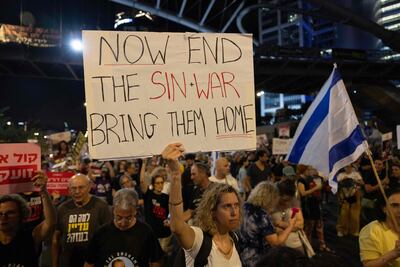 Supporters and relatives of Israelis held hostage by Palestinian militants in Gaza since the October 7 attacks, hold placards and wave national flags during a demonstration calling for their release.