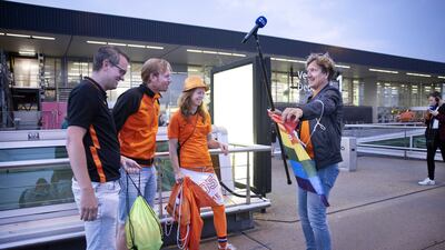 Dutch presenter Klaas van Kruistum hands football fans a rainbow flag during recordings for the TV program 'Klaas anything is possible,' at Amsterdam Airport Schiphol, near Amsterdam, The Netherlands, 27 June 2021. Van Kruistum hopes to convince fans to speak out in Hungary against the anti-gay law. The Dutch team plays against the Czech Republic in their UEFA EURO 2020 round of 16 soccer match in the Hungarian capital. EPA / RAMON VAN FLYMEN