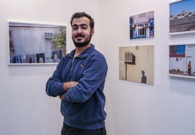 Ahmed Al Kuwaiti in front of his work during the exhibition launch for 50 Years of Cool. Victor Besa / The National