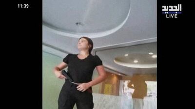 A woman, identified as Sally Hafez, appears to be carrying a gun at a Blom Bank branch in Beirut, in this screengrab taken from Al Jadeed footage. Reuters