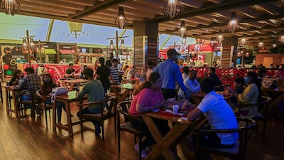 People eat a meal at a food court in a New Delhi mall. Inflation is rising in India, driven by higher oil prices. AFP