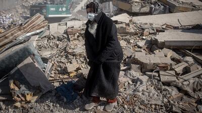 HATAY, TURKEY - FEBRUARY 15: A relative waits amid rubble as rescue workers recover the body of a loved one on February 15, 2023 in Hatay, Turkey. A 7.8-magnitude earthquake hit near Gaziantep, Turkey, in the early hours of February 6, followed by another 7.5-magnitude tremor just after midday. The quakes caused widespread destruction in southern Turkey and northern Syria and has killed more than 30,000 people. (Photo by Chris McGrath / Getty Images)