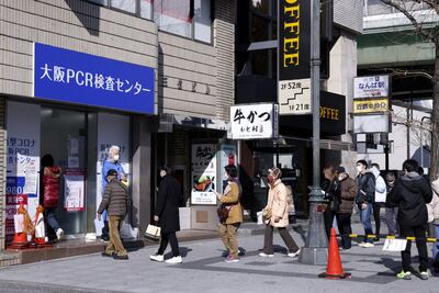Members of the public enter a Covid-19 polymerase chain reaction (PCR) testing site in Osaka, Japan, on Thursday, Jan. 27, 2022. Japan is reckoning with a surge in omicron cases that’s burdening the health-care system and prompting an overhaul in how the virus is handled. Photographer: Kiyoshi Ota / Bloomberg