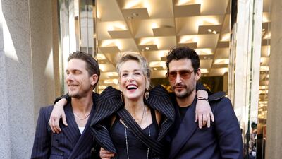 MILAN, ITALY - FEBRUARY 26: Adam Senn, Sharon Stone and Sam Webb attend a photocall during a Dolce & Gabbana boutique event during the Milan Fashion Week Fall/Winter 2022/2023 on February 26, 2022 in Milan, Italy. (Photo by Andreas Rentz / Getty Images)