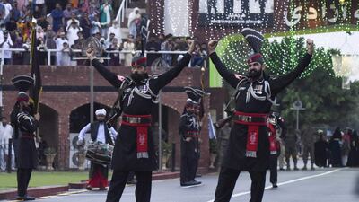 This picture taken on August 15, 2022, shows Pakistani Rangers (in black) taking part in the Beating the Retreat ceremony during India's 75th Independence Day celebrations at the India-Pakistan Wagah border post, about 35km from Amritsar. (Photo by Narinder NANU / AFP)