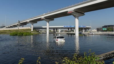 An abandoned Nissan Patrol parked in a flooded area under the Dubai metro line. Antonie Robertson / The National