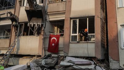 HATAY, TURKEY - FEBRUARY 13: A rescuer checks a partly damaged building on February 13, 2023 in Hatay, Turkey. A 7.8-magnitude earthquake hit near Gaziantep, Turkey, in the early hours of Monday, followed by another 7.5-magnitude tremor just after midday. The quakes caused widespread destruction in southern Turkey and northern Syria and were felt in nearby countries. (Photo by Burak Kara / Getty Images)