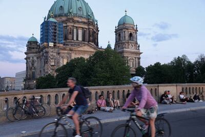 People relax on a warm summer evening as the Dom Cathedral stands behind during the coronavirus pandemic on June 09, 2021 in Berlin, Germany. Getty Images