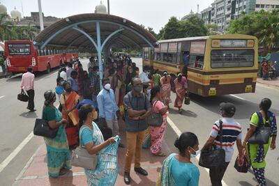 Indian people wait for a bus at a bus stop in Chennai, India, 23 June 2021. Tamil Nadu state government eases ongoing lockdown as it resumes bus services in four districts of the state with lower Covid-19 cases. EPA / IDREES MOHAMMED