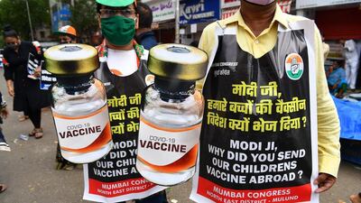 Congress party activists hold cut-outs of Covid-19 coronavirus vaccine vials during a protest against the vaccine shortage in Mumbai, India. AFP