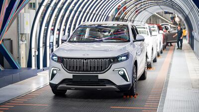 This photograph taken in Bursa on May 17, 2024 shows employees working on a car assembly line at a factory of Togg at the Gemlik Togg Technology Campus. Thousands of vehicles are rolling off its ‘campus’ on the Sea of Marmara, built in less than two years. Already renowned for its car manufacturing, Turkey is showing its teeth in the electric car market with its champion, Togg. (Photo by Yasin AKGUL / AFP)
