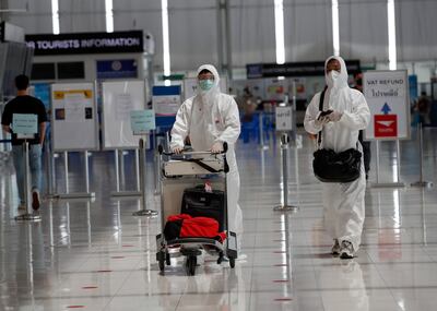 Chinese passengers wearing fully protective suits to prevent the spreading of the COVID-19 pandemic arrive at the international departures area of Suvarnabhumi Airport in Samut Prakan province, Thailand, 22 June 2021. Thailand is set to fully reopen the country to vaccinated foreign tourists to restart its tourism industry in the middle of October 2021, despite the surging cases and rising death tolls of the coronavirus disease (COVID-19) pandemic. EPA / RUNGROJ YONGRIT