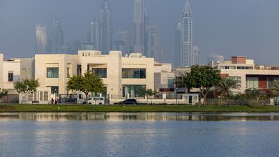 Residential villas on the waterside of the Emirates Hills district backdropped by residential skyscrapers beyond in the Dubai Marina district of Dubai, United Arab Emirates, on Wednesday, Feb. 23, 2022. A government committee set up before the pandemic enlisted some of Dubai’s largest developers as members to try to manage supply and demand in the property market and ensure that state-owned businesses don’t crowd out private builders. Photographer: Christopher Pike / Bloomberg