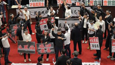 Votes are counted as ruling Democratic Progressive Party politicians raise their fists during a ballot for parliamentary reform in Taipei, Taiwan. AFP