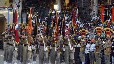 This picture taken on August 15, 2022, shows Indian Border Security Force (BSF) soldiers taking part in the Beating the Retreat ceremony during India's 75th Independence Day celebrations at the India-Pakistan Wagah border post, about 35km from Amritsar. (Photo by Narinder NANU / AFP)